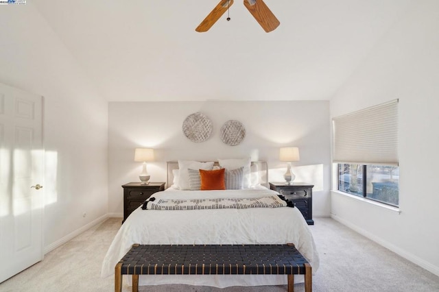 bedroom with ceiling fan, vaulted ceiling, and light carpet