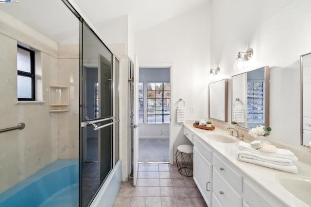 bathroom with enclosed tub / shower combo, tile patterned floors, vanity, and lofted ceiling