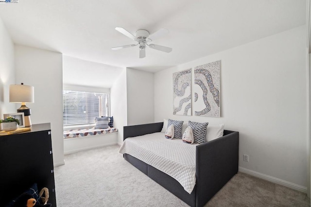 bedroom with light carpet and ceiling fan