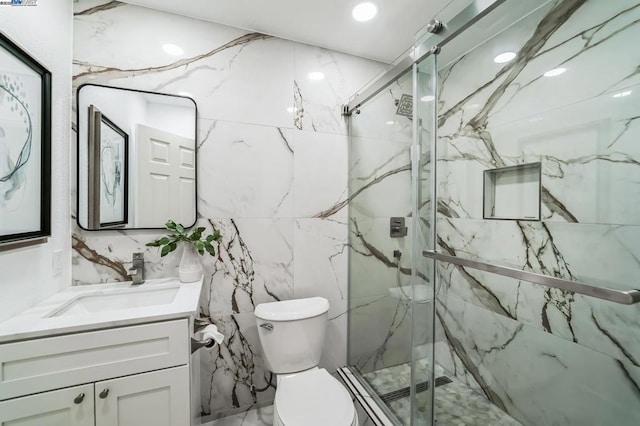 bathroom with walk in shower, vanity, and toilet