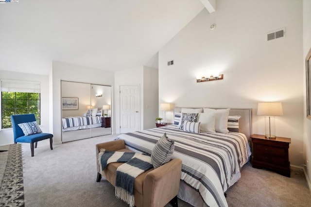 carpeted bedroom featuring beam ceiling and high vaulted ceiling