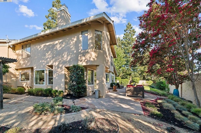 back of house featuring an outdoor hangout area and a patio