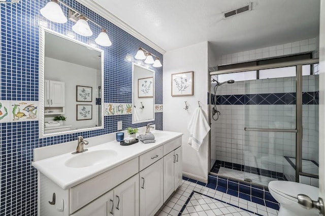 bathroom with tile patterned flooring, vanity, a shower with door, and toilet