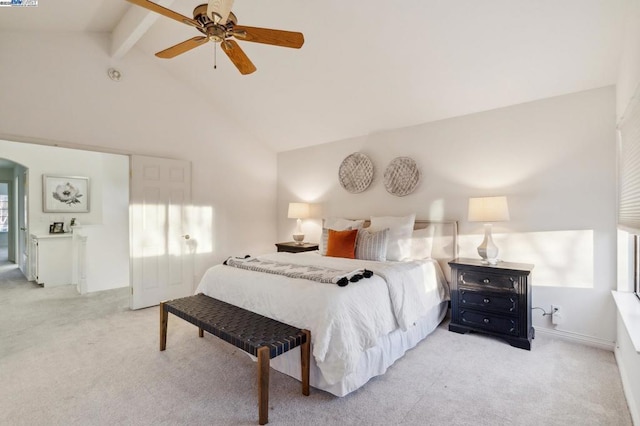 carpeted bedroom featuring lofted ceiling with beams and ceiling fan