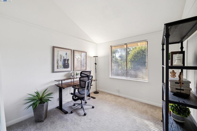 carpeted office featuring vaulted ceiling