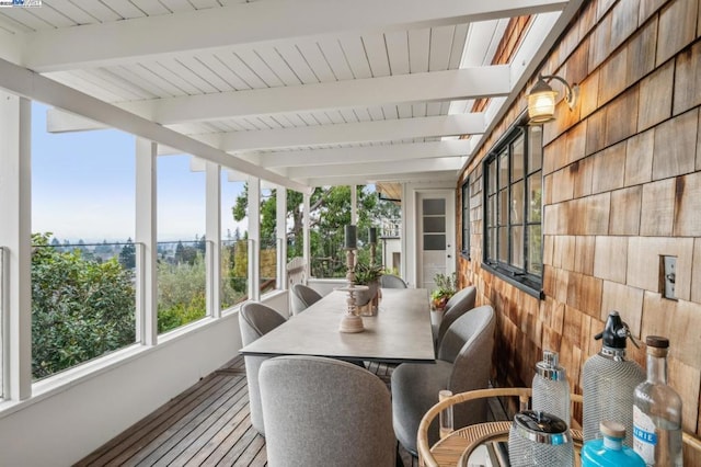 sunroom with beamed ceiling