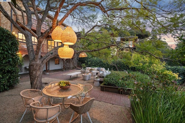 patio terrace at dusk featuring outdoor lounge area