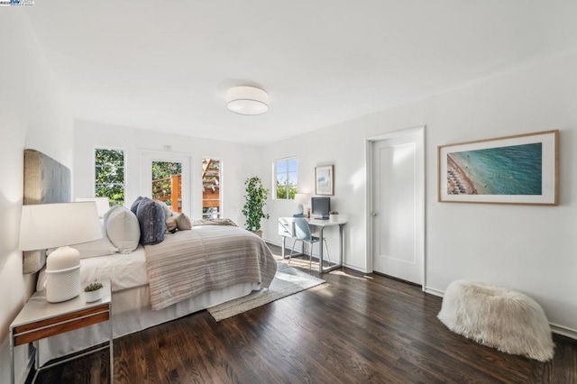 bedroom with dark hardwood / wood-style flooring