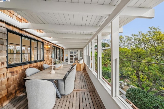 sunroom / solarium with a skylight and beamed ceiling