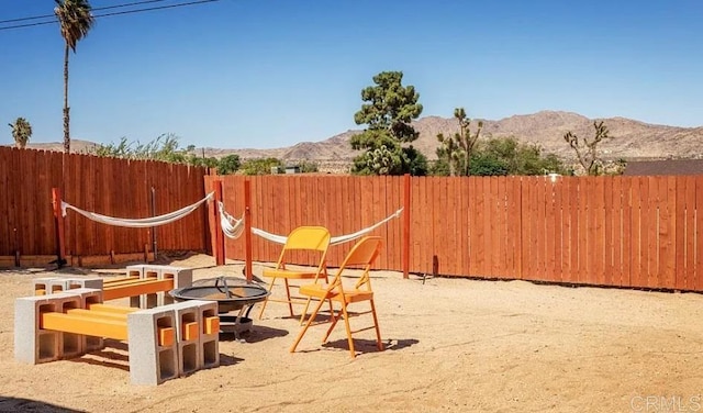 view of patio featuring a mountain view and an outdoor fire pit