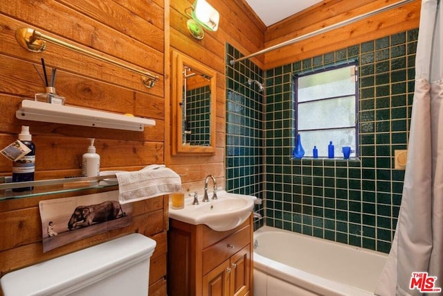 full bathroom with wood walls, vanity, shower / tub combo with curtain, and toilet