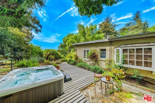 deck featuring a hot tub