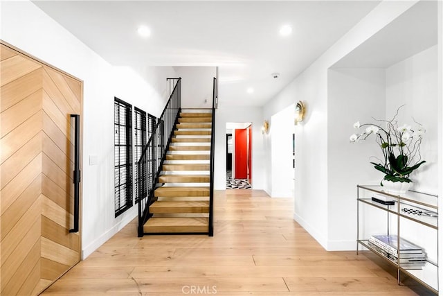 stairway featuring hardwood / wood-style floors and plenty of natural light