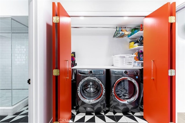 washroom with washing machine and clothes dryer