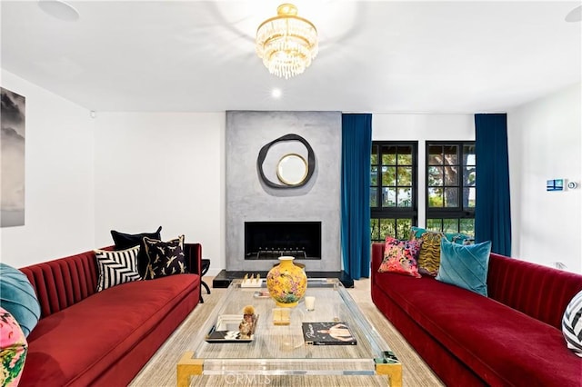 living room featuring a fireplace and a chandelier