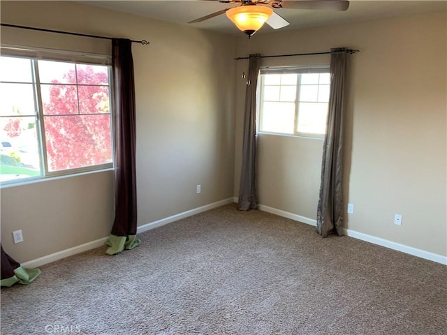 carpeted spare room with ceiling fan