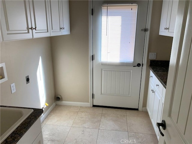 laundry room featuring cabinets, washer hookup, hookup for an electric dryer, and light tile patterned floors