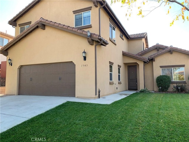 view of front of house featuring a garage and a front lawn