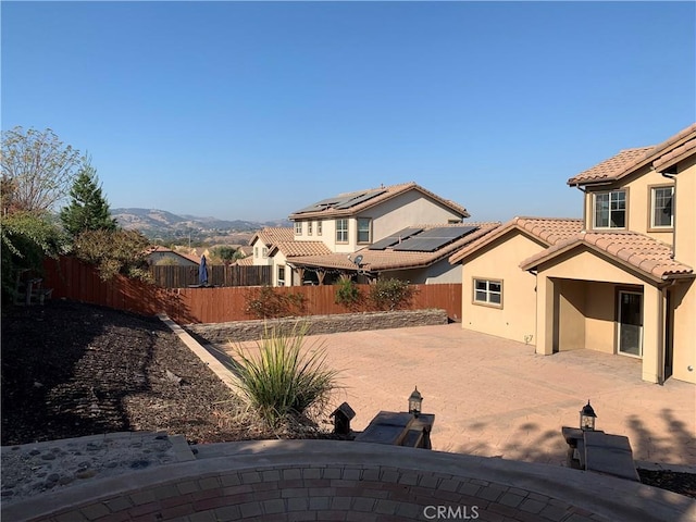 view of yard featuring a mountain view and a patio area