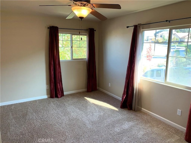 empty room with light colored carpet and ceiling fan