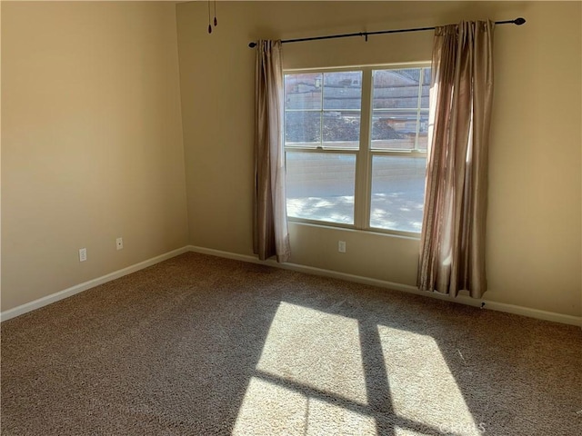 carpeted spare room featuring plenty of natural light