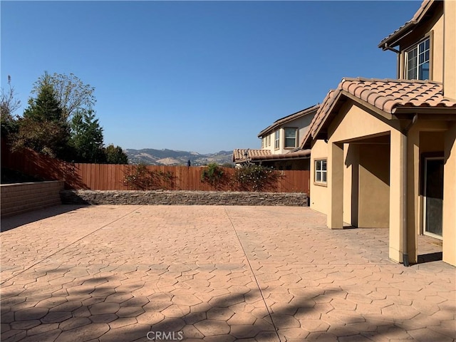 view of yard with a mountain view and a patio