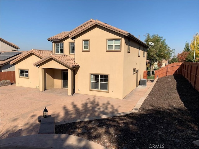 back of property with cooling unit and a patio area