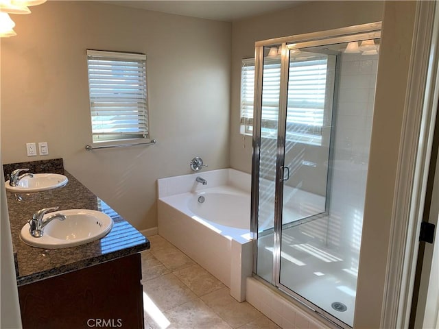 bathroom with tile patterned flooring, vanity, separate shower and tub, and a wealth of natural light