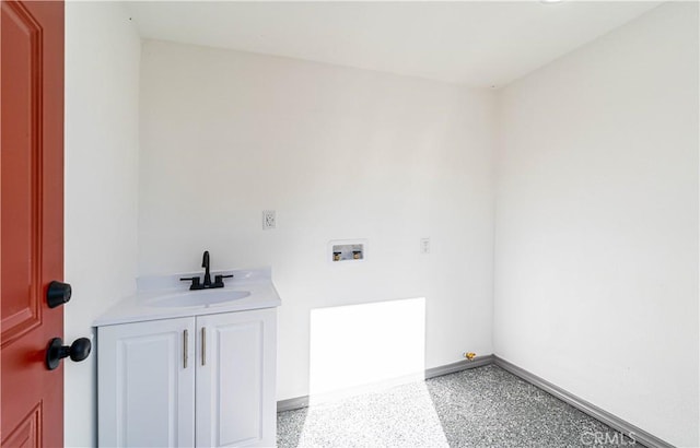 laundry room featuring washer hookup, sink, and cabinets