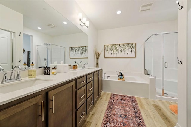 bathroom featuring vanity, hardwood / wood-style flooring, and independent shower and bath