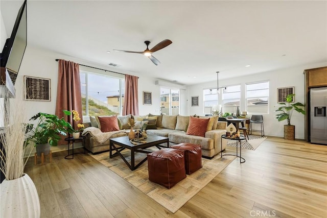 living room featuring ceiling fan and light wood-type flooring