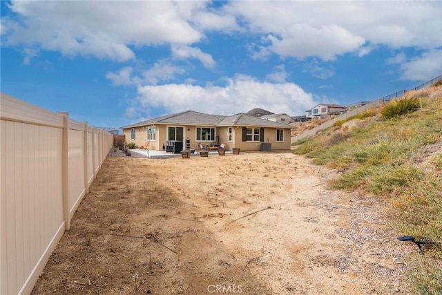 back of property with a patio