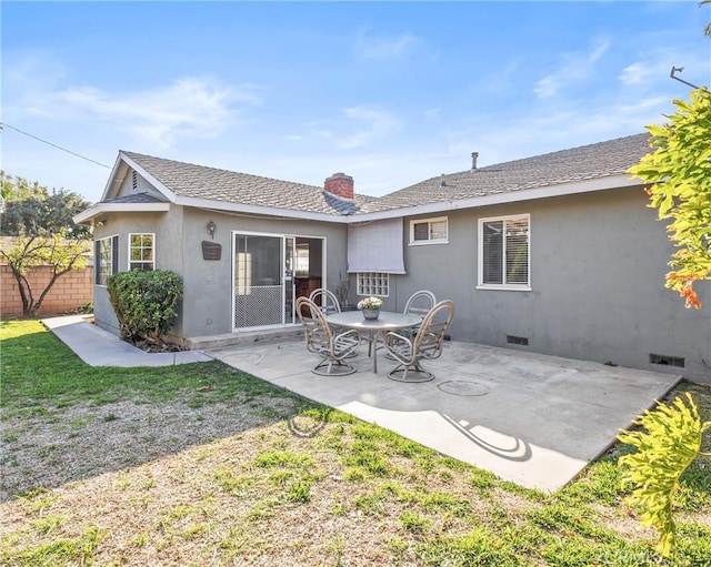 rear view of house with a lawn and a patio area