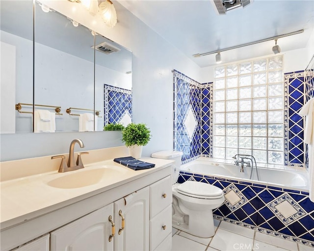 bathroom with track lighting, vanity, toilet, and tile patterned flooring