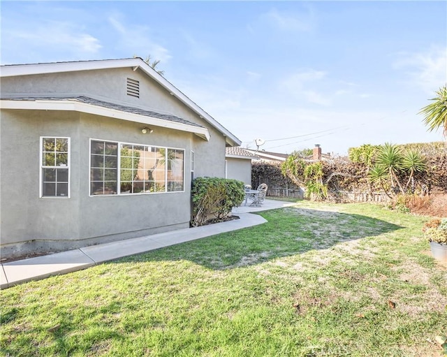 exterior space with a lawn and a patio area