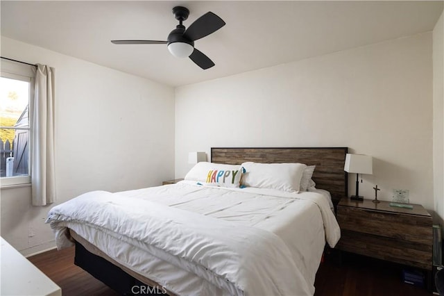 bedroom with dark wood-type flooring and ceiling fan