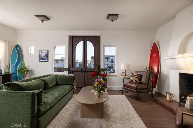 living room with crown molding and dark hardwood / wood-style floors