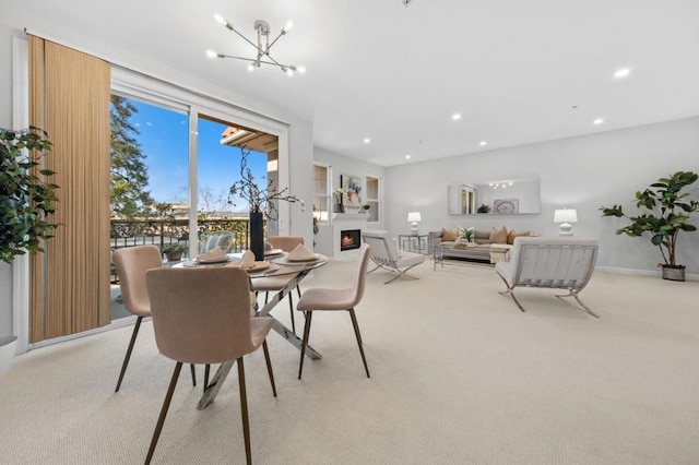 carpeted dining room with an inviting chandelier