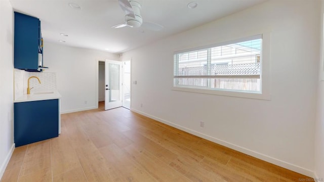 interior space featuring ceiling fan, sink, and hardwood / wood-style floors