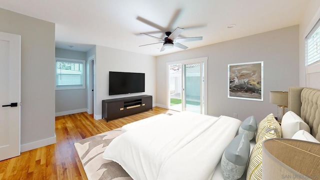 bedroom with hardwood / wood-style flooring, ceiling fan, and access to exterior