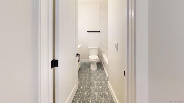 bathroom with tile patterned flooring, vanity, toilet, and walk in shower