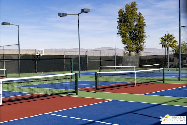 view of sport court featuring a mountain view and basketball court