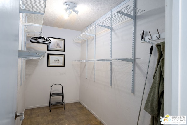 spacious closet featuring parquet floors