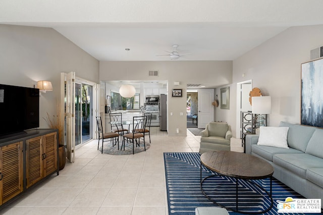 living room with light tile patterned flooring, ceiling fan, and vaulted ceiling