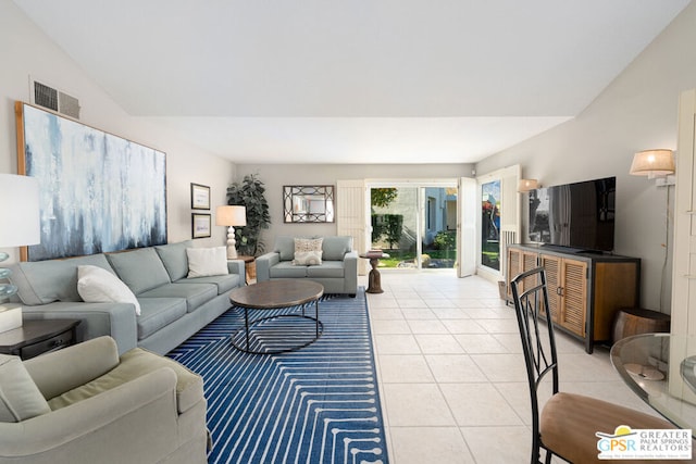 tiled living room featuring vaulted ceiling