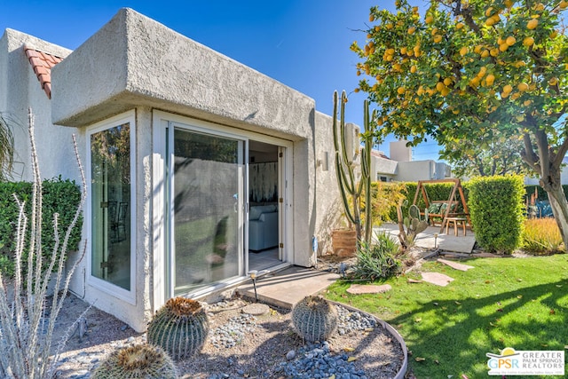 rear view of property featuring a yard and a patio