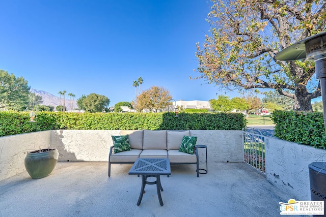 view of patio / terrace with an outdoor living space and a mountain view