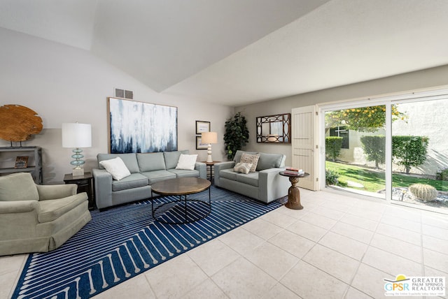 living room with lofted ceiling and light tile patterned floors