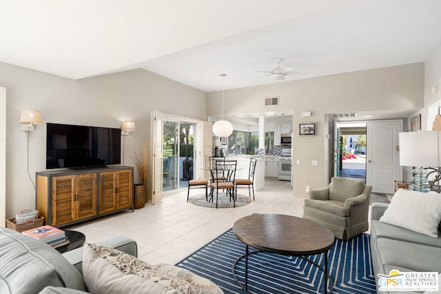 tiled living room featuring lofted ceiling and ceiling fan