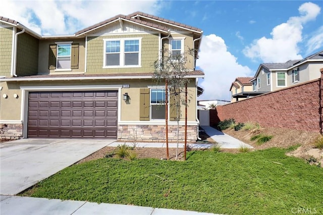 craftsman inspired home featuring a garage and a front lawn